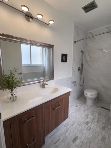 Primary bath has a walk-in ADA shower