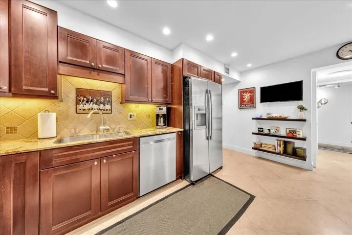 Kitchen featuring cherry wood cabinetry, stainless steel appliances, granite-countertops, and recessed lighting