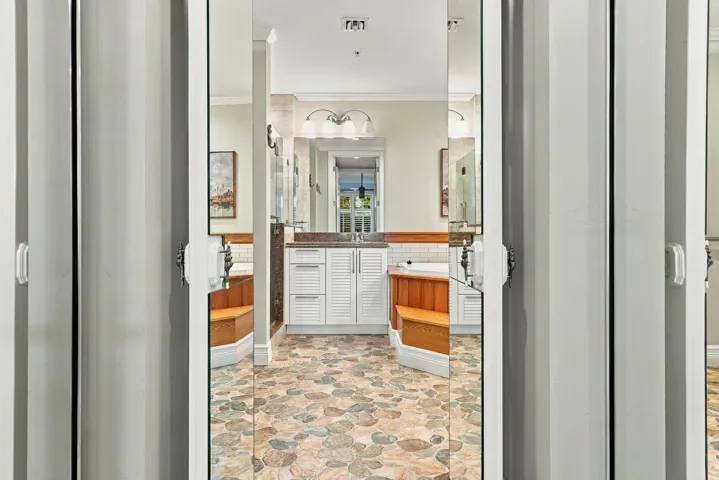 One of two custom walk-in closets in primary suite. Notice the built-in dresser.
