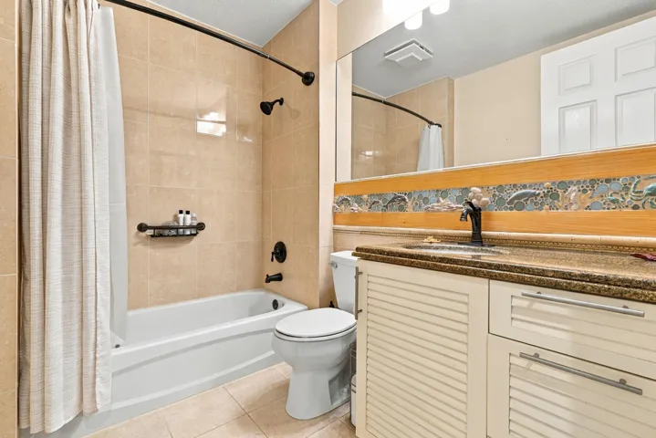 Guest bath has a fun/beachy backsplash over custom vanity. Updated lighting, built-in medicine cabinet, and updated faucets are a few of the other features.