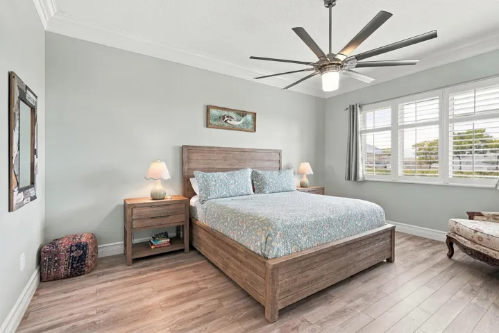 Spacious primary suite overlooks marina.