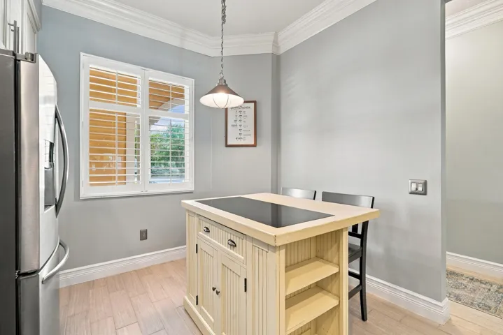 Movable island provides for seating, extra cabinet space, and a place to put hot dishes.