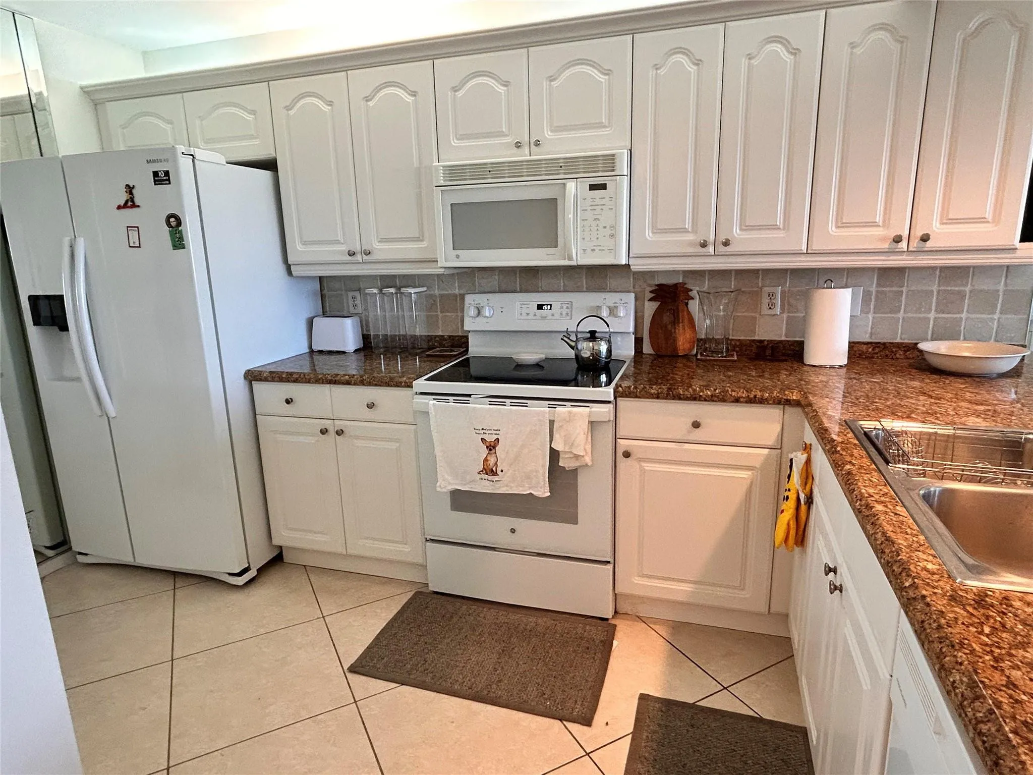 White cabinetry with arch panel doors and silver-tone hardware