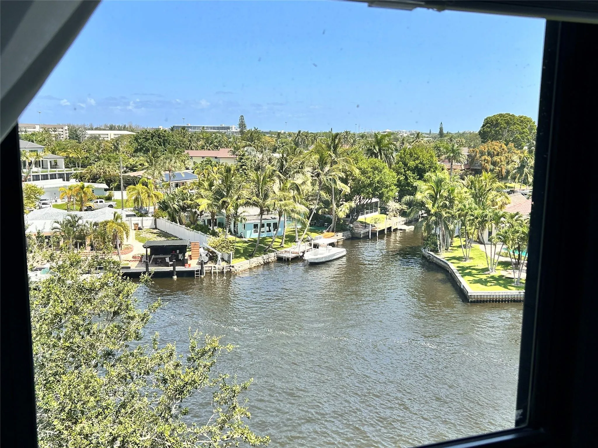 Waterfront scenery featuring canals, tropical foliage, and residential properties