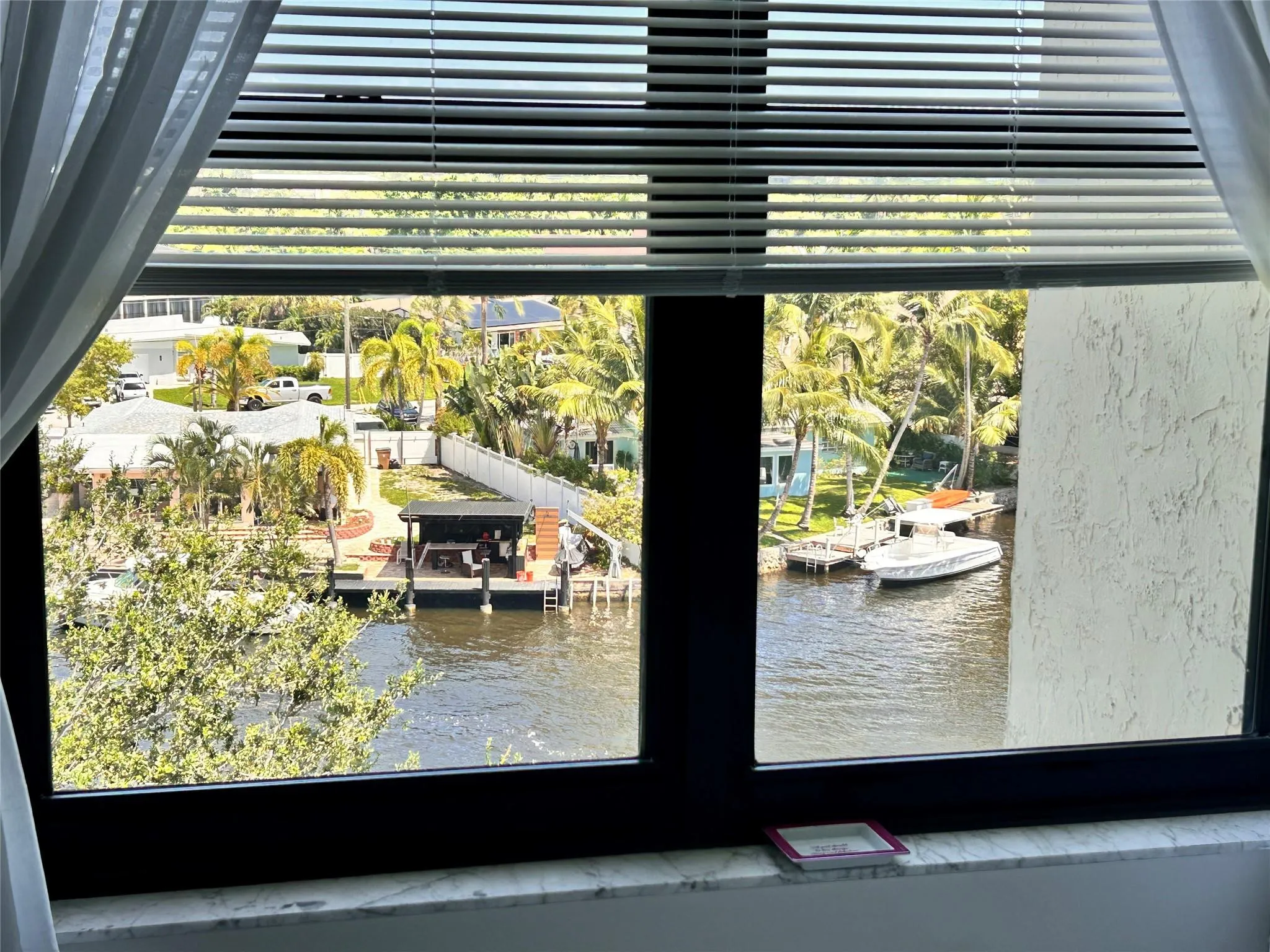 Waterfront scenery with a boat dock and tropical foliage