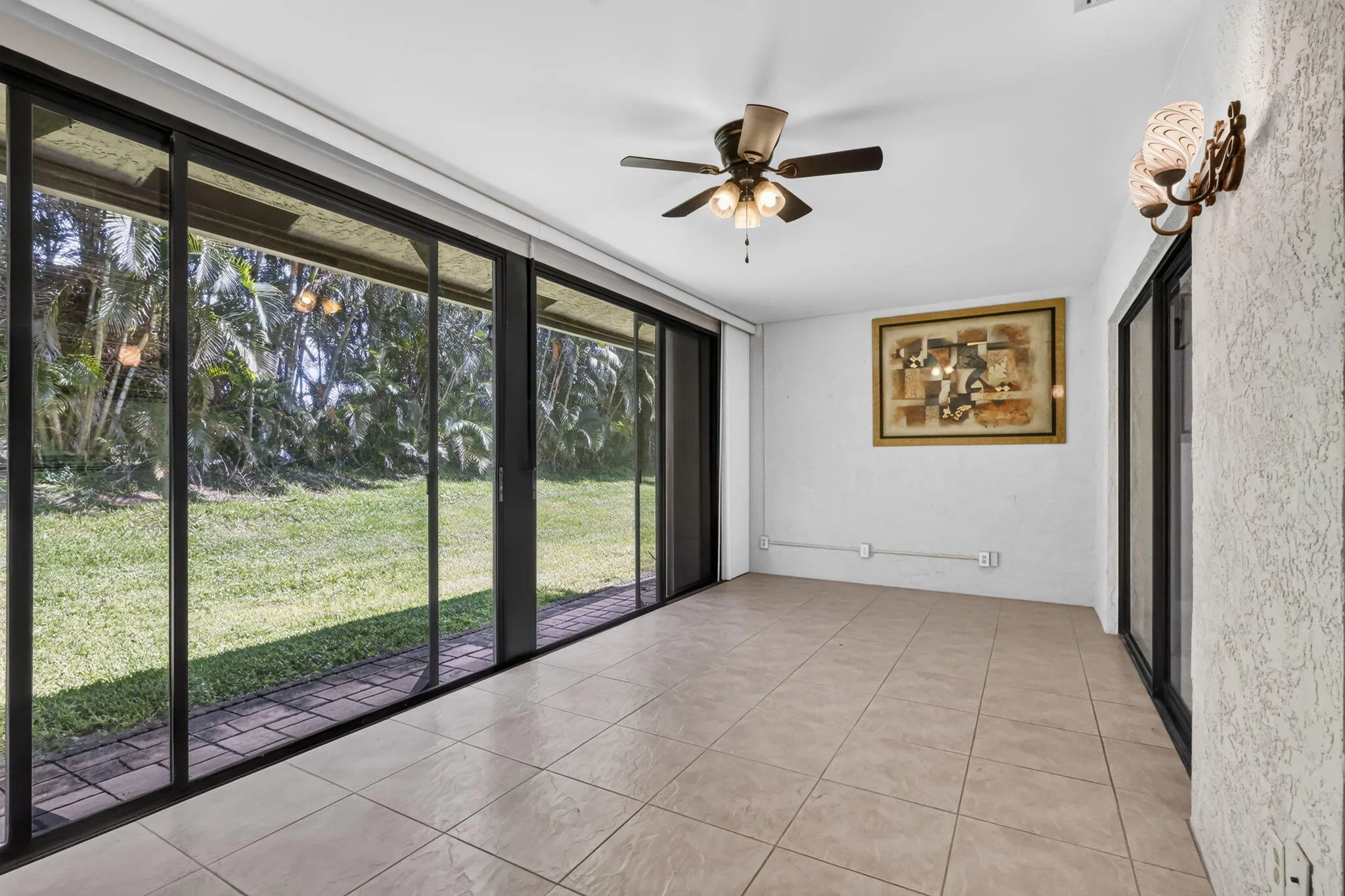 Large enclosed patio off living room and primary bedroom area