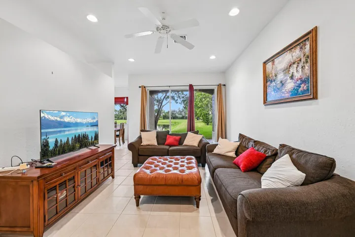 Living area with tile flooring, recessed lighting, and a ceiling fan
