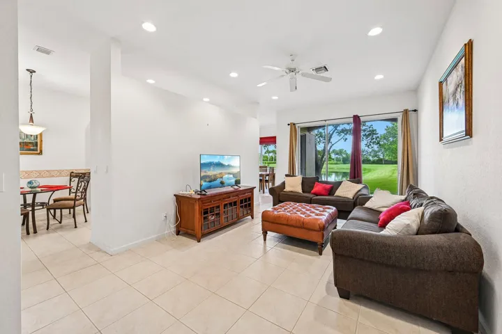 Tile flooring, recessed lighting, ceiling fan, and sliding glass doors