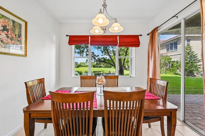 Open dining area with a window, a sliding glass door, and a chandelier