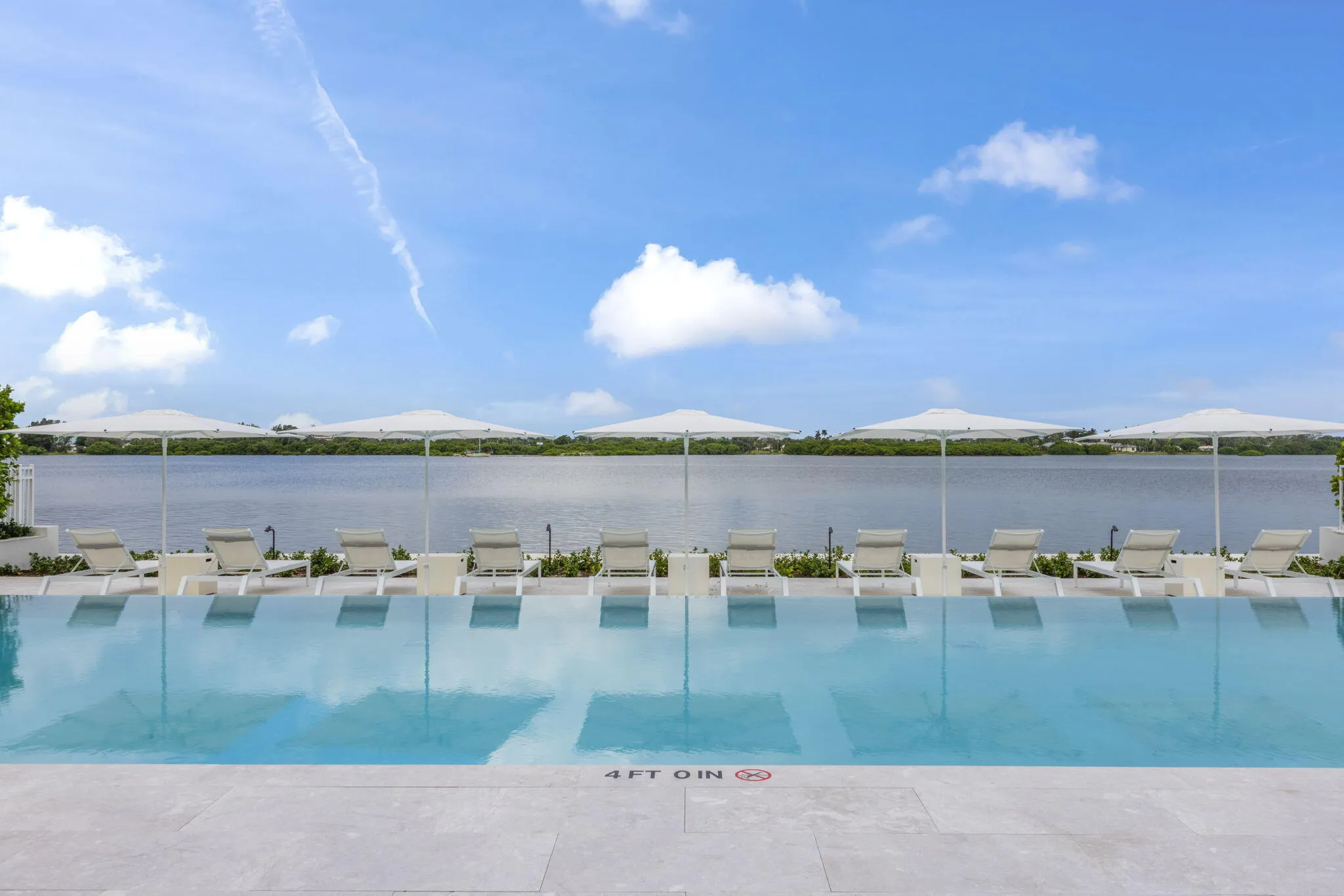 Infinity-edge pool with surrounding light-toned paving