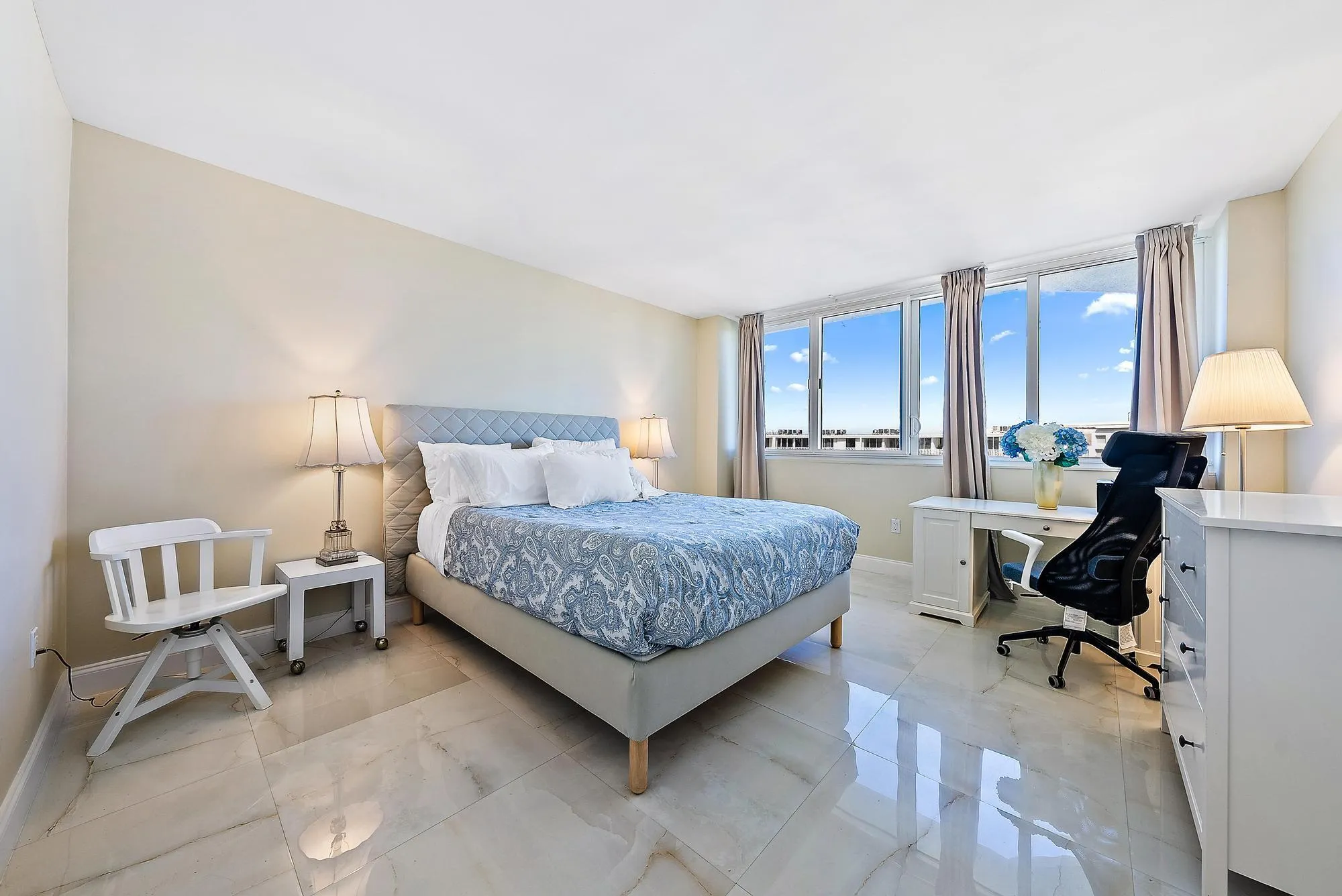 Expansive windows, high ceilings, and light-toned walls
