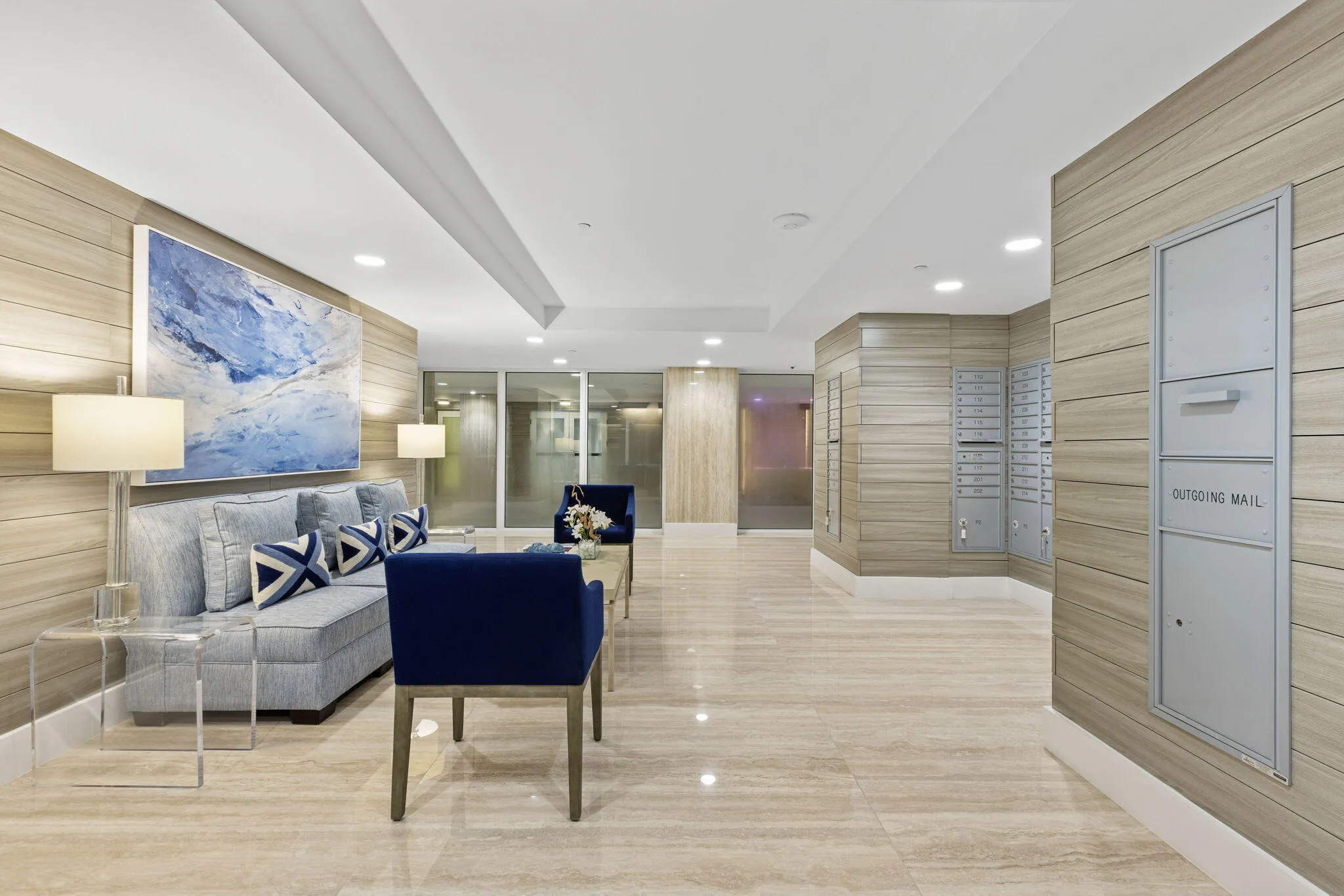 Marble-style tile flooring, wood-finish wall paneling, and an integrated lighting system create a refined space