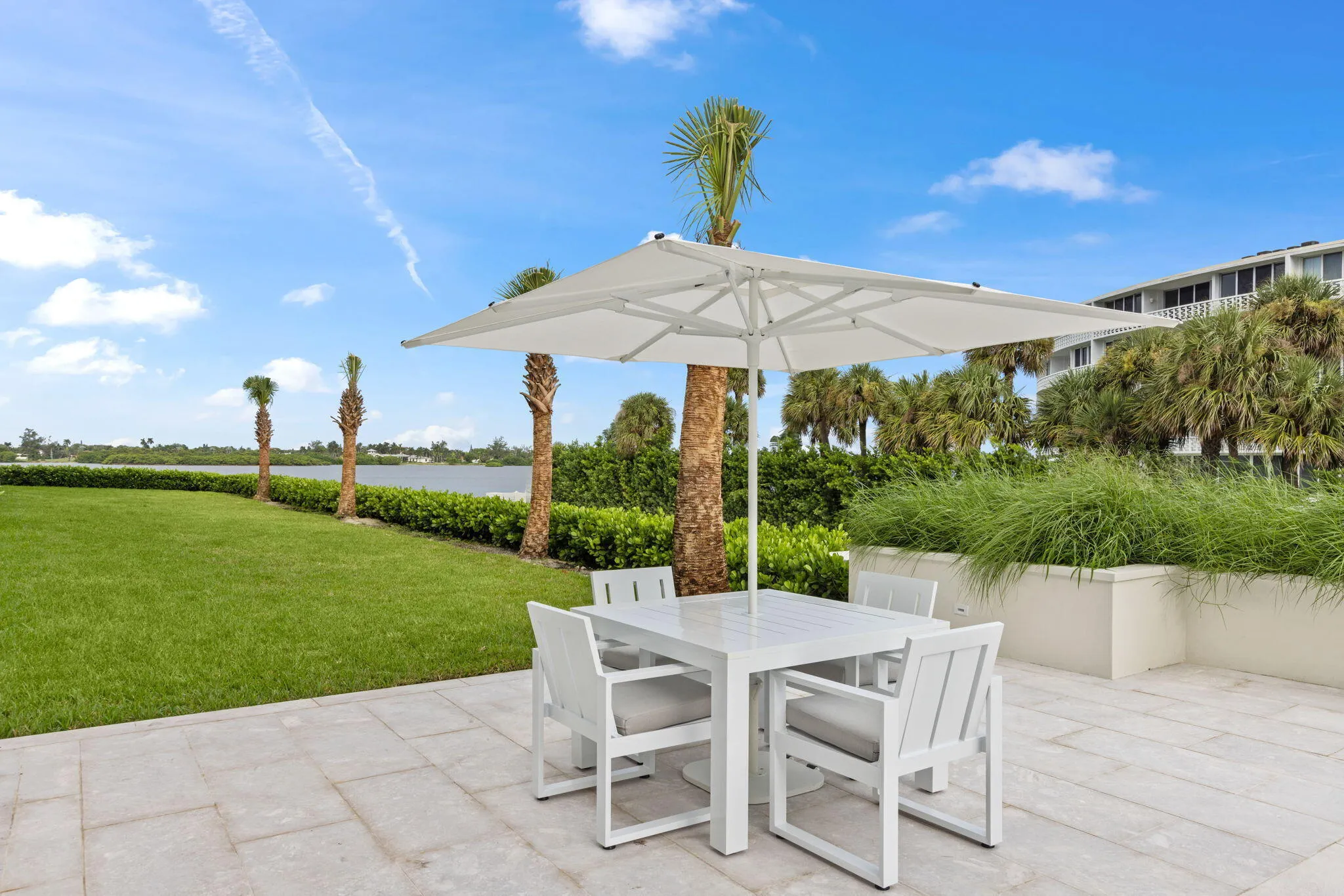 Expansive patio featuring a square umbrella and a rectangular table