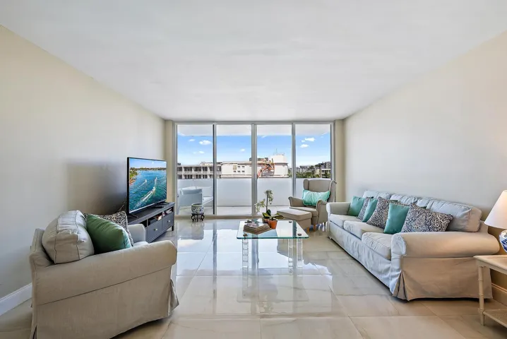 High-gloss tile flooring, floor-to-ceiling glass doors, and a private balcony