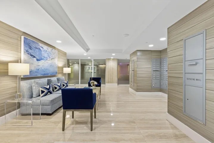 Marble-style tile flooring, wood-finish wall paneling, and an integrated lighting system create a refined space