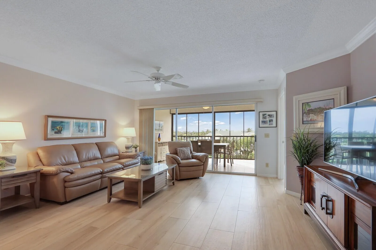 Living room with 3-panel glass slider door to Lanai