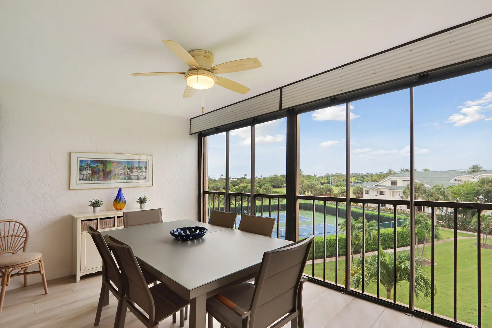 Covered & screened-in balcony / Lanai with peekaboo view of Atlantic Ocean. Overlooking Carlin Park, garden views, tennis courts and Bella Vista lake.