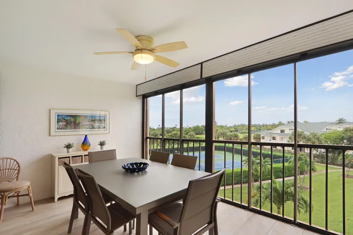 Covered & screened-in balcony / Lanai with peekaboo view of Atlantic Ocean. Overlooking Carlin Park, garden views, tennis courts and Bella Vista lake.