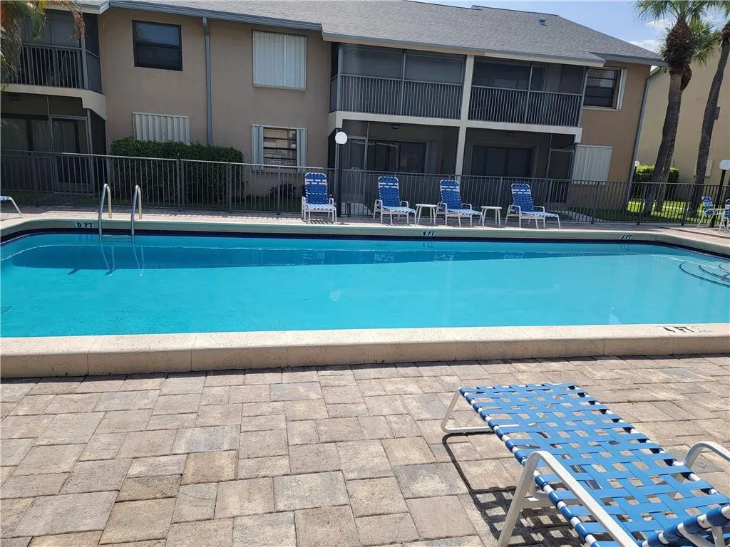 Community swimming pool with a paved deck