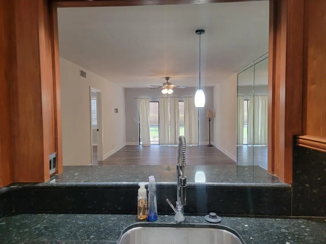 Wood-finish cabinetry framing a pass-through opening