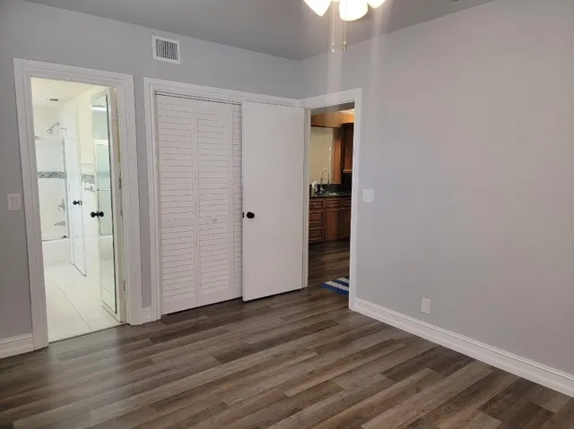 Wood-finish flooring, light gray wall paint, and white trim