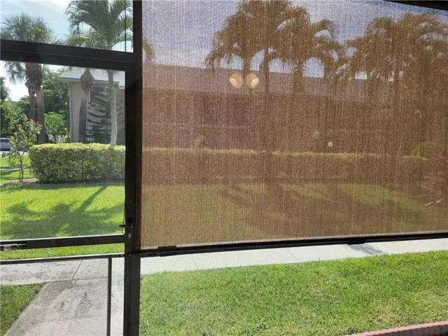 Screened enclosure with textured roller shade