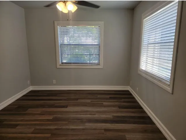 Wood-finish flooring, light gray wall paint, and white trim