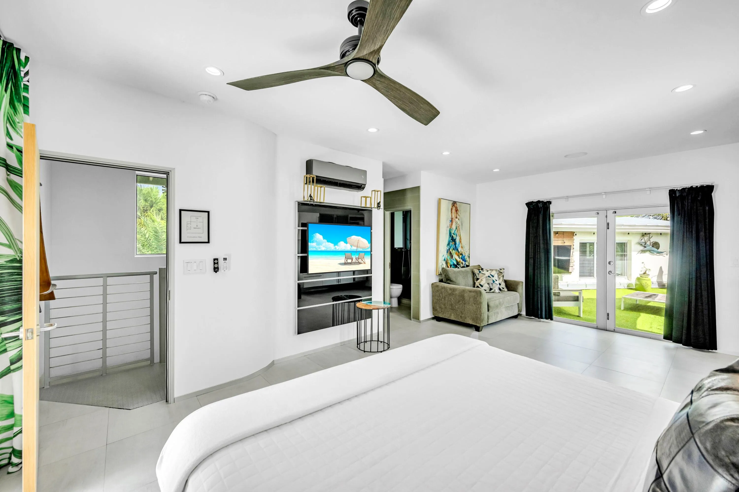 Recessed lighting, ceiling fan, built-in media console, sliding glass door, and hard surface flooring