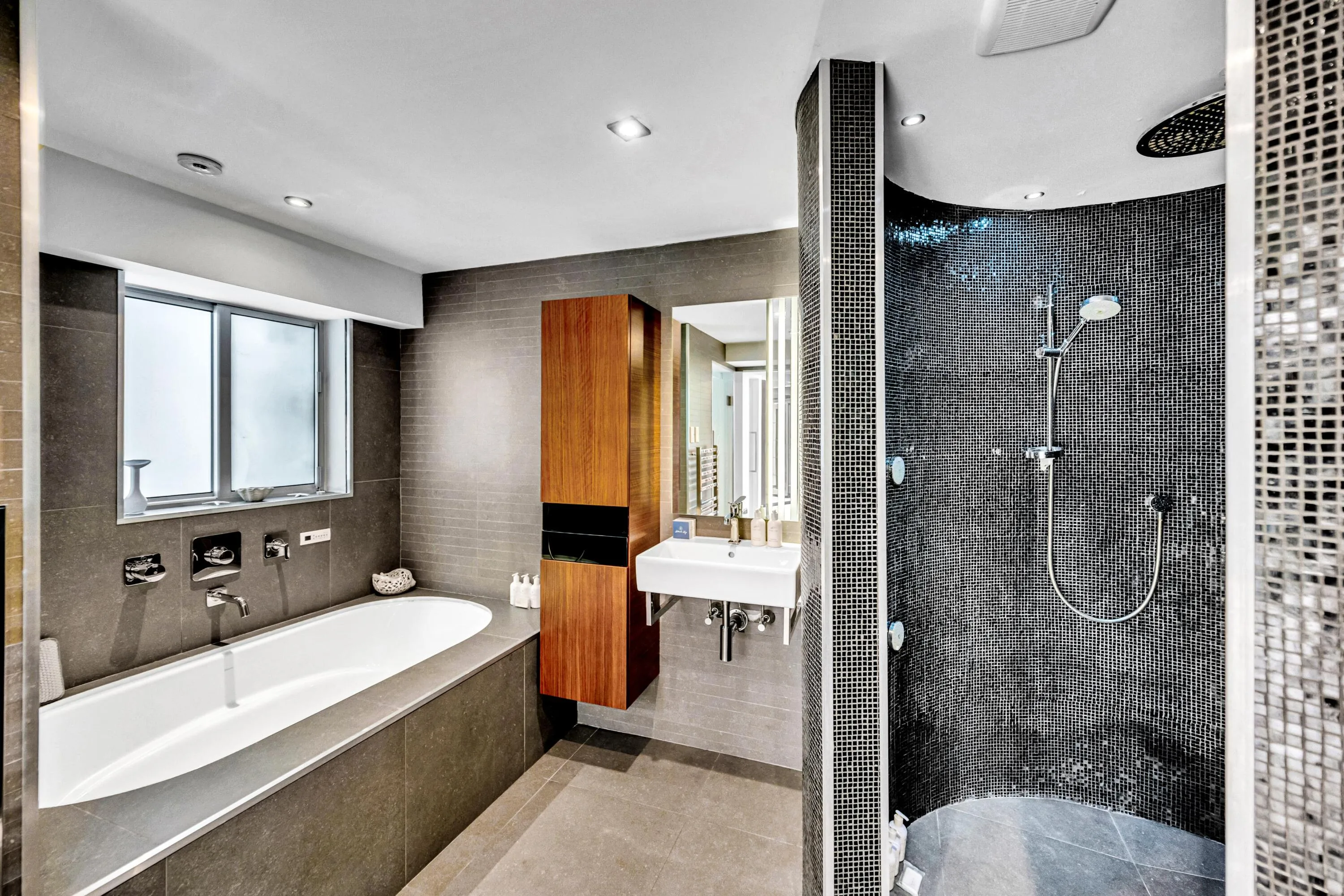 Deep soaking tub with wall-mounted fixtures