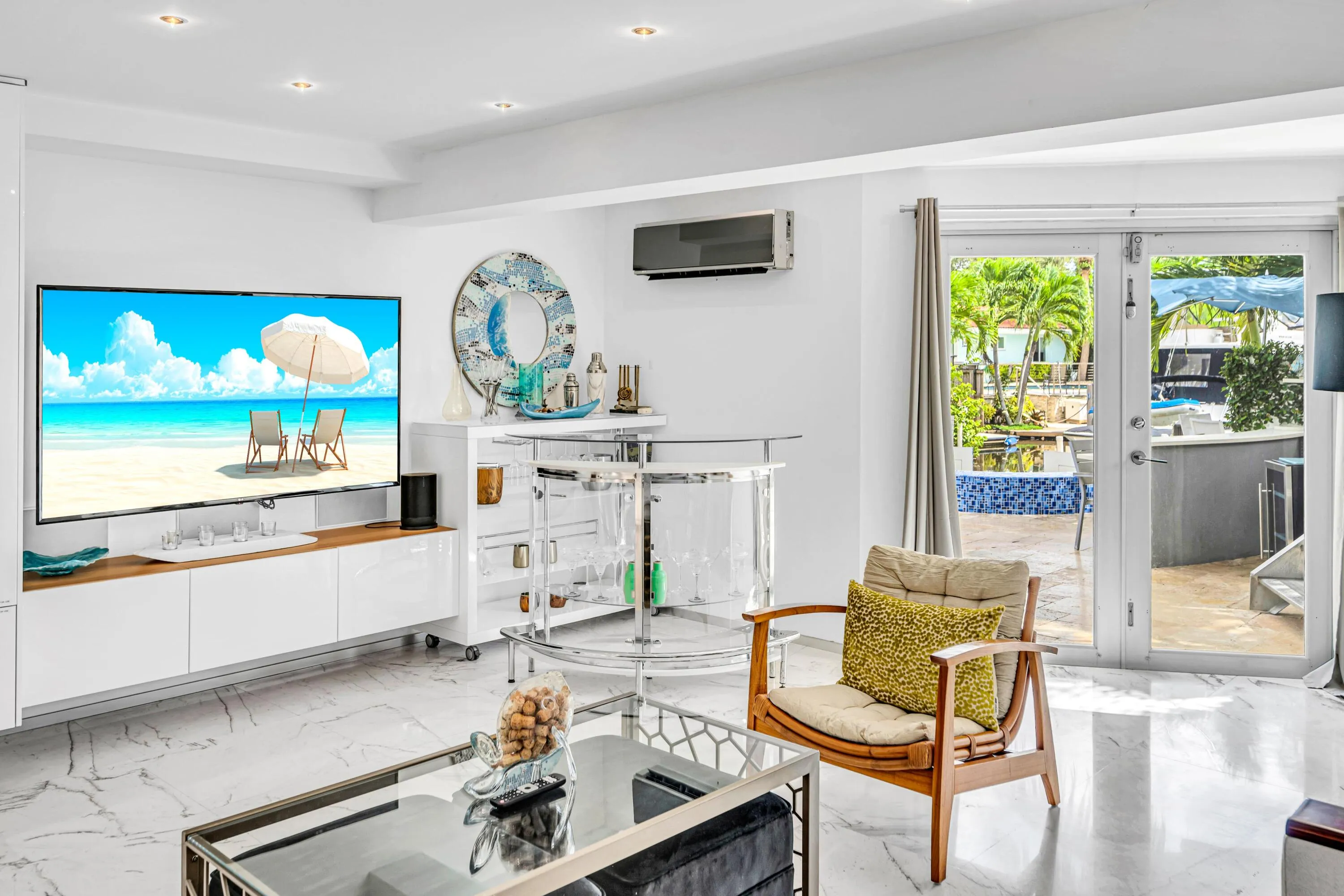 Recessed lighting, sleek white cabinetry, and large format marble-look flooring