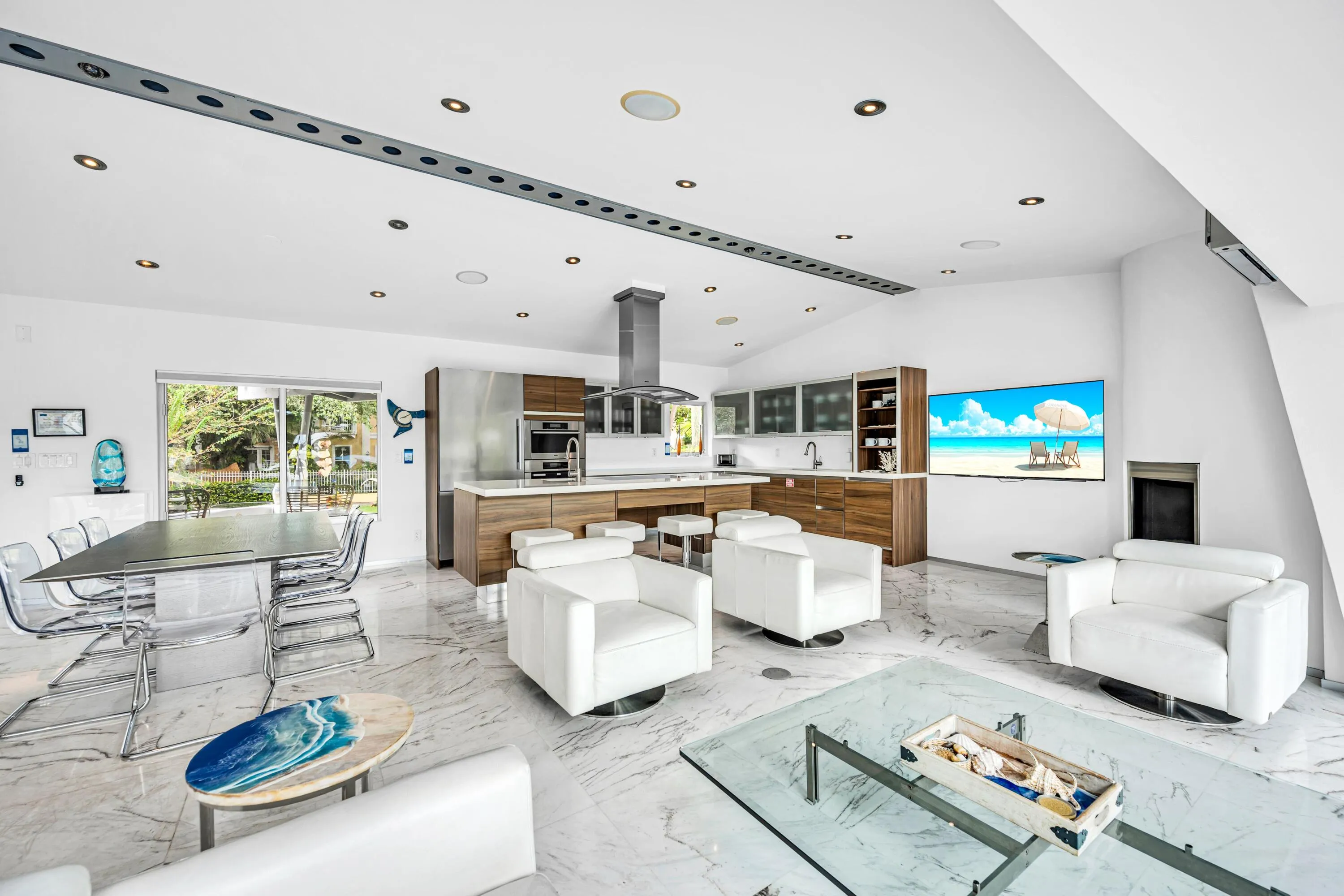 Modern kitchen with wood-finish cabinetry, stainless steel appliances, and a central island