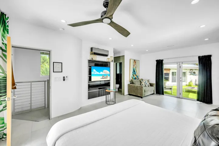 Recessed lighting, ceiling fan, built-in media console, sliding glass door, and hard surface flooring