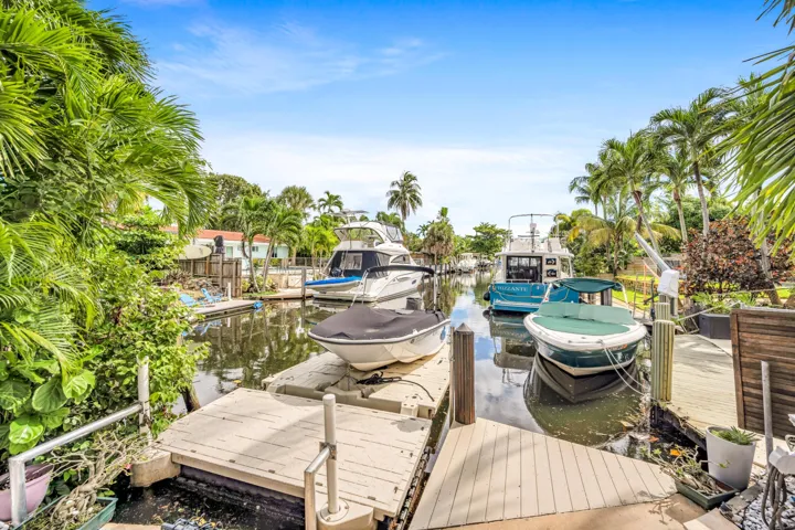 Waterfront canal access with multiple docks and lush tropical landscaping