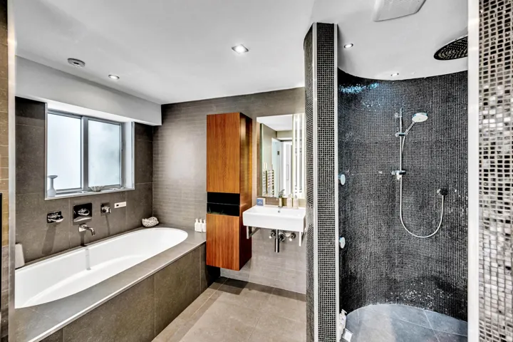 Deep soaking tub with wall-mounted fixtures