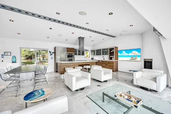 Modern kitchen with wood-finish cabinetry, stainless steel appliances, and a central island