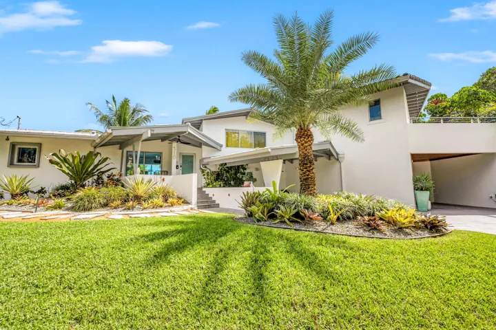 Contemporary architecture featuring a partial two-story design, a covered entry, and a covered carport