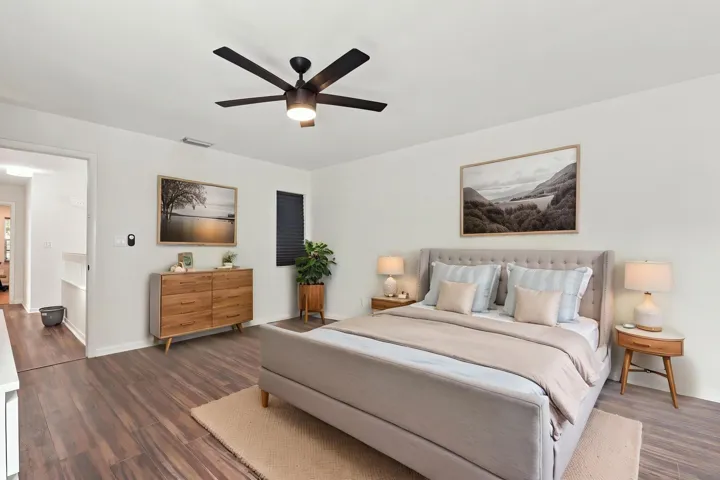 The elegant primary suite offers a private retreat with a beautifully updated bathroom, spacious walk-in closets, and a private balcony overlooking the backyard. It is the perfect place to enjoy your morning coffee while taking in the peaceful setting and mature trees surrounding the community.
