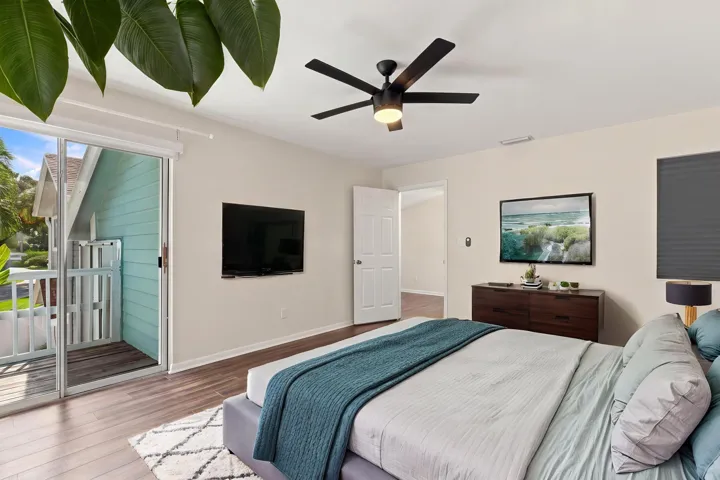 The elegant primary suite offers a private retreat with a beautifully updated bathroom, spacious walk-in closets, and a private balcony overlooking the backyard. It is the perfect place to enjoy your morning coffee while taking in the peaceful setting and mature trees surrounding the community.