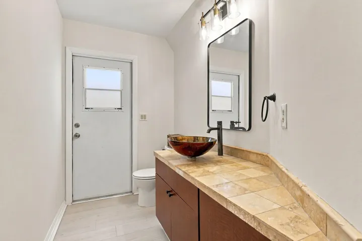 Tastefully updated and conveniently located just off the living room, the powder room offers comfort and convenience for residents and guests alike.