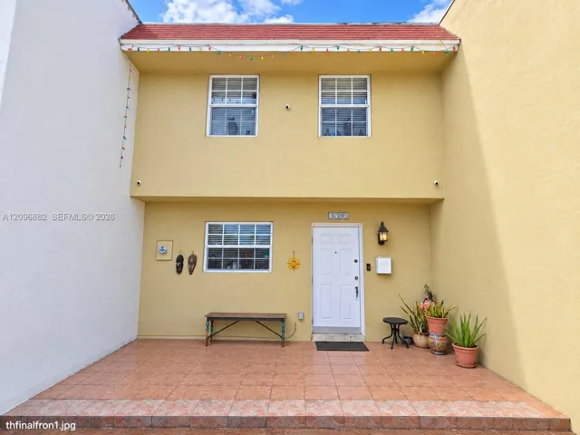Welcoming front entrance featuring a spacious tiled patio area and a nicely sized driveway with ample space.