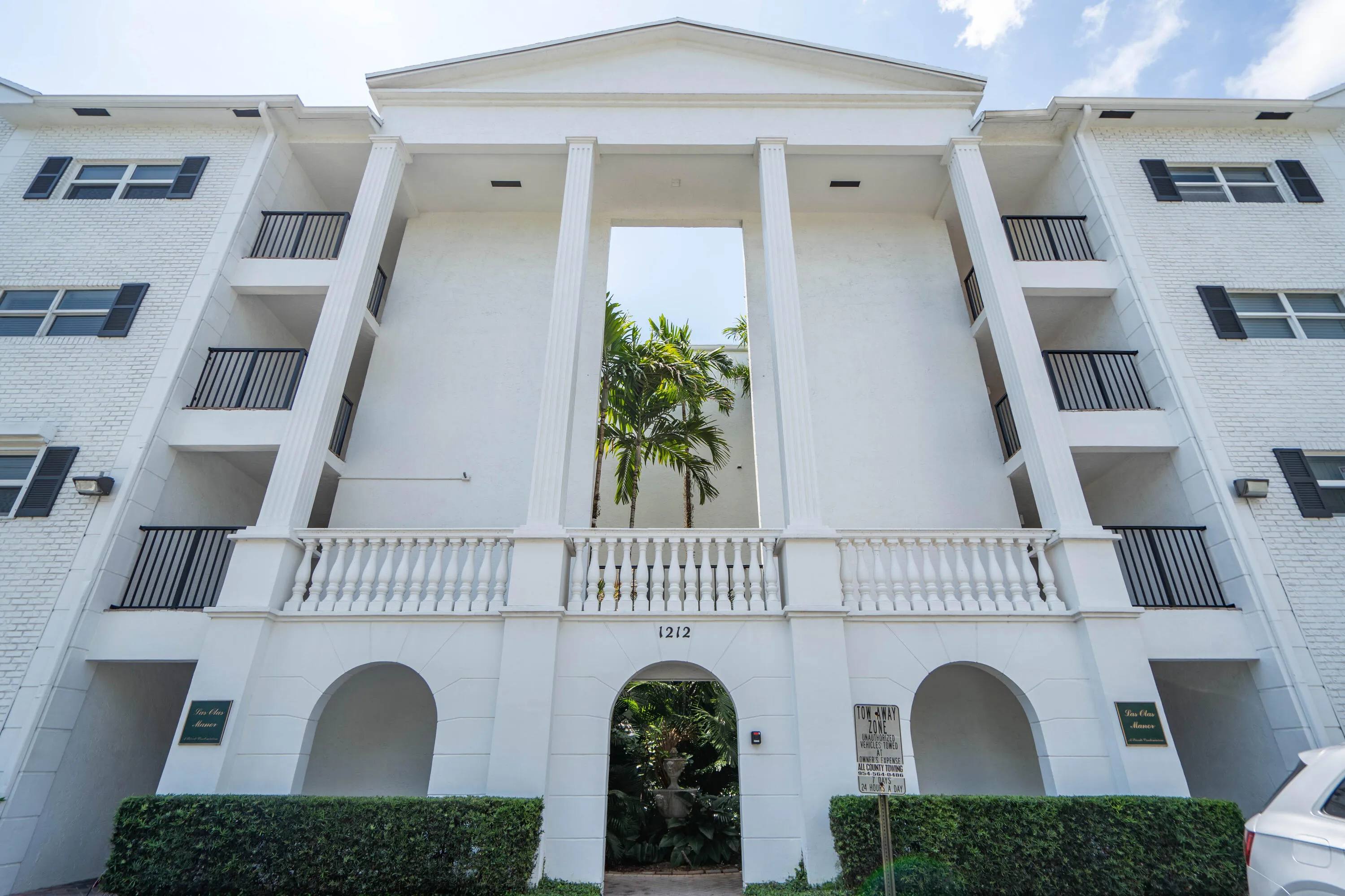White brick facade with black louvered shutters