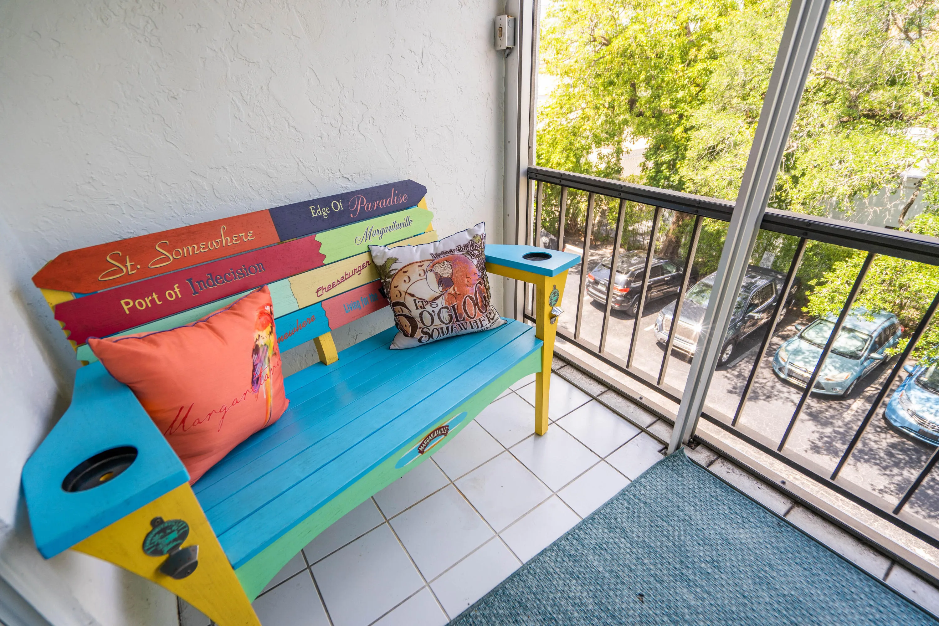 Enclosed balcony with white tile flooring and black metal railings