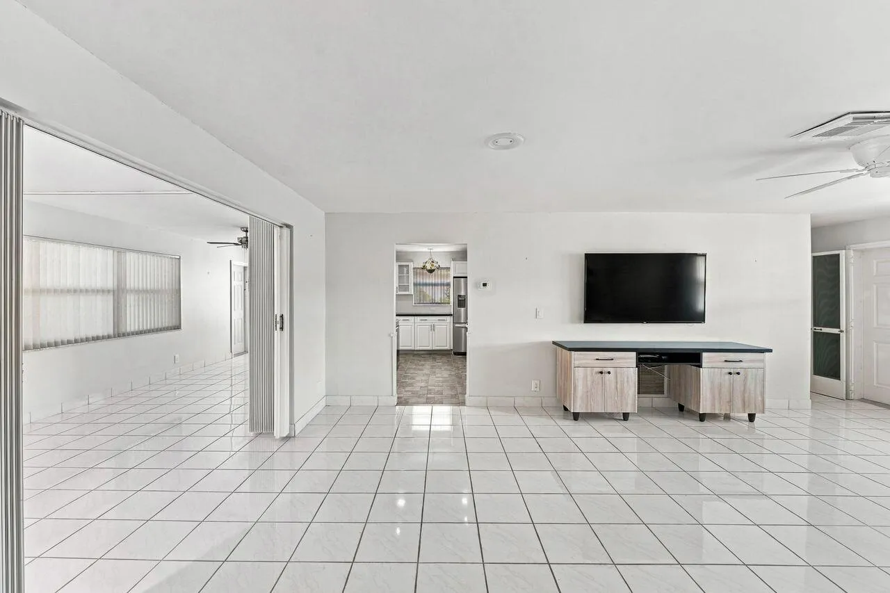 Large and open living room adjoining kitchen and family room