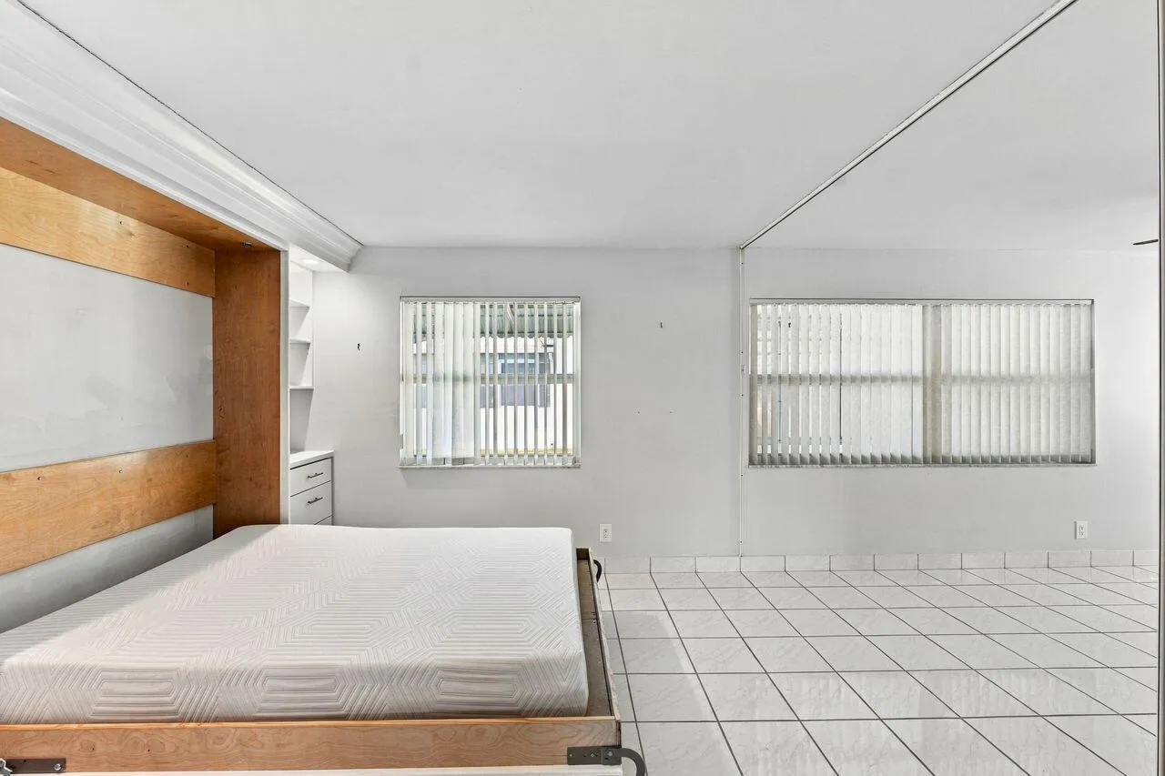 Gorgeous Murphy bed with built-in shelving and recessed lighting, creates a flexible space