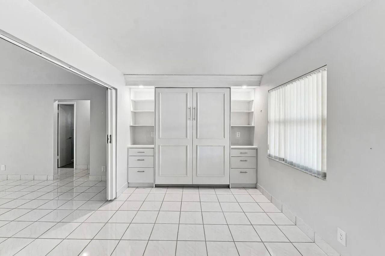Large living space with a gorgeous Murphy Bed & Bookshelves for extra sleeping accommodations
