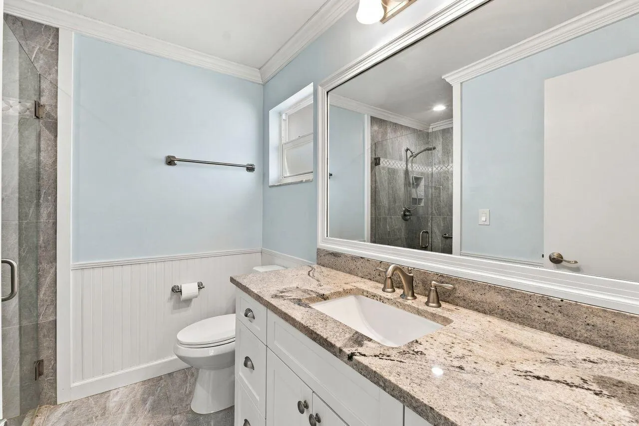 Light blue walls with white wainscoting and totally updated