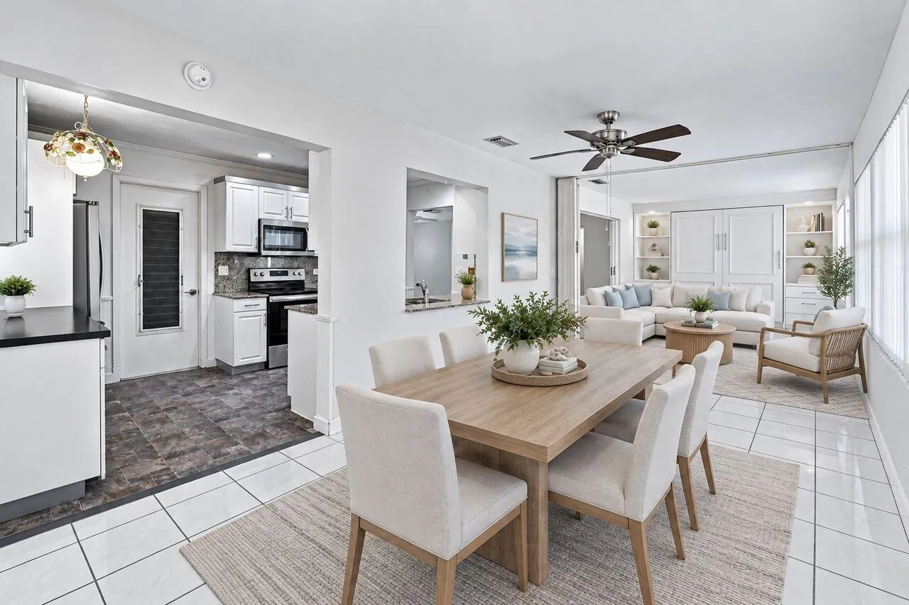 Spacious dining room/family room area with exterior door to enclosed patio. (Virtually Staged)