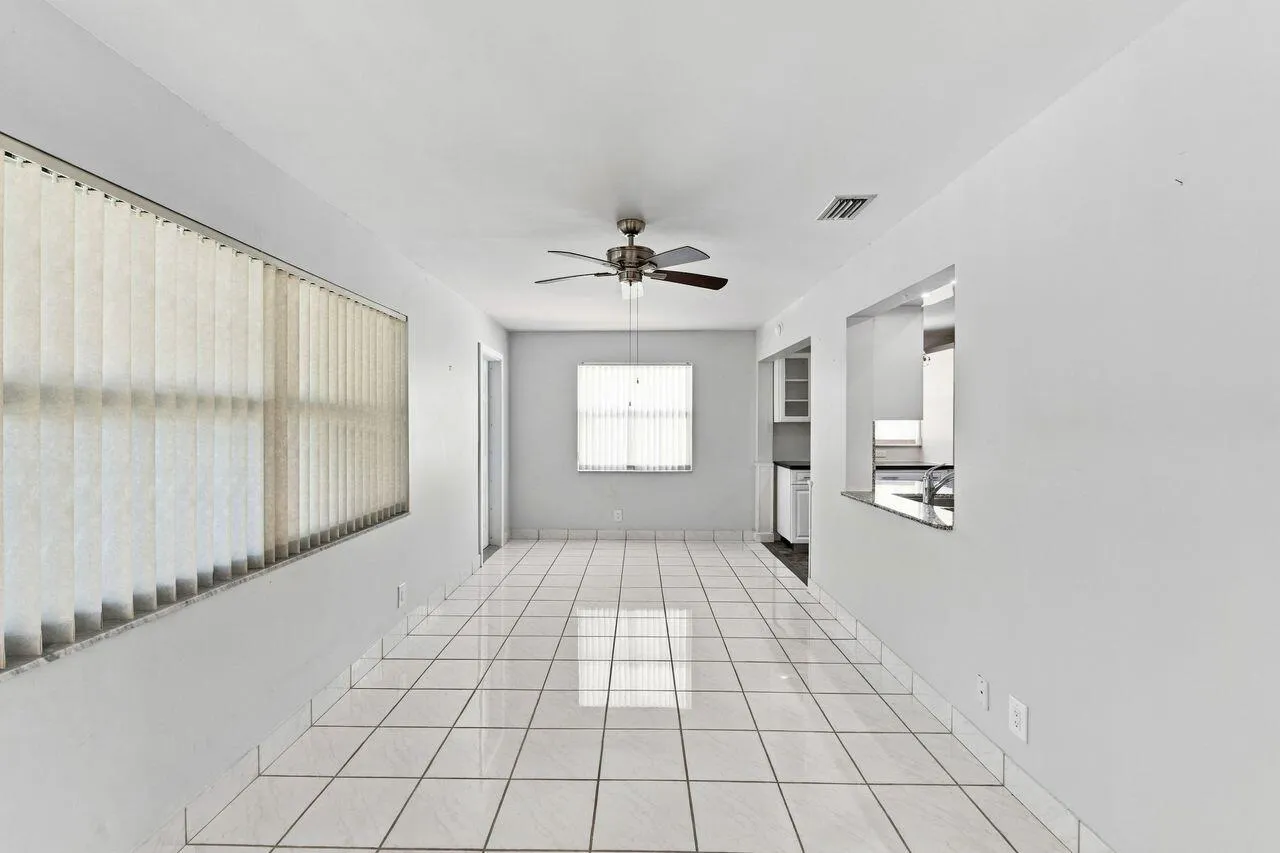 Large, open area with pass through to kitchen and entrance to outside patio