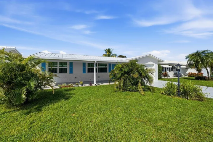 Lovely ranch style home with newer metal roof and impact windows and doors