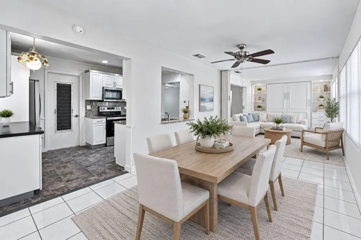 Spacious dining room/family room area with exterior door to enclosed patio. (Virtually Staged)
